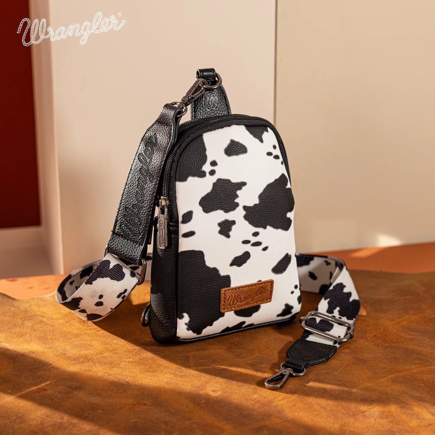 Wrangler Cow Print Crossbody Sling Chest Bag- BLACK